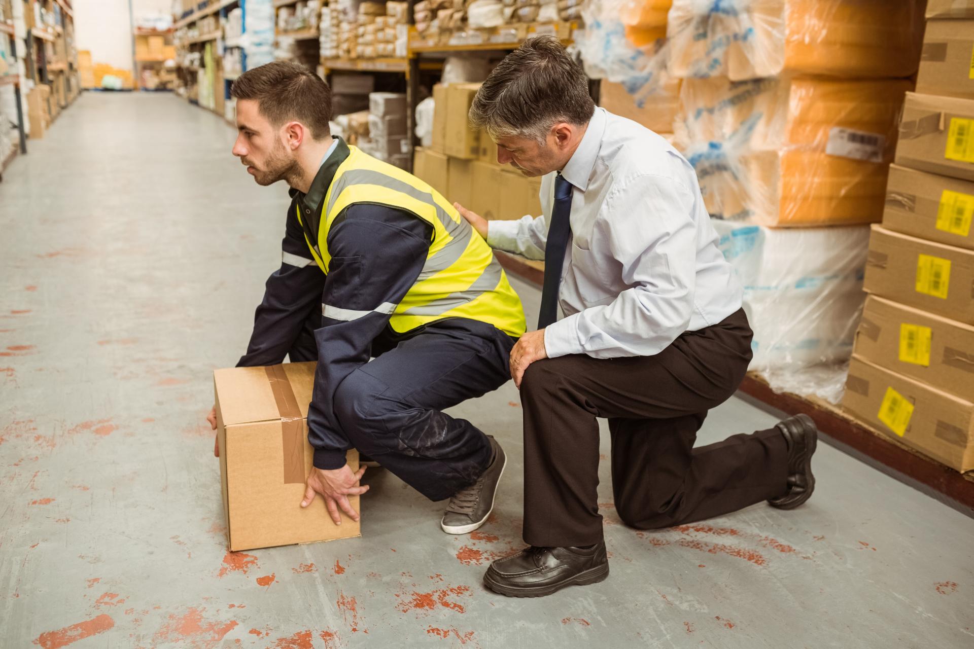 Manager training worker for health and safety measure in a large warehouse