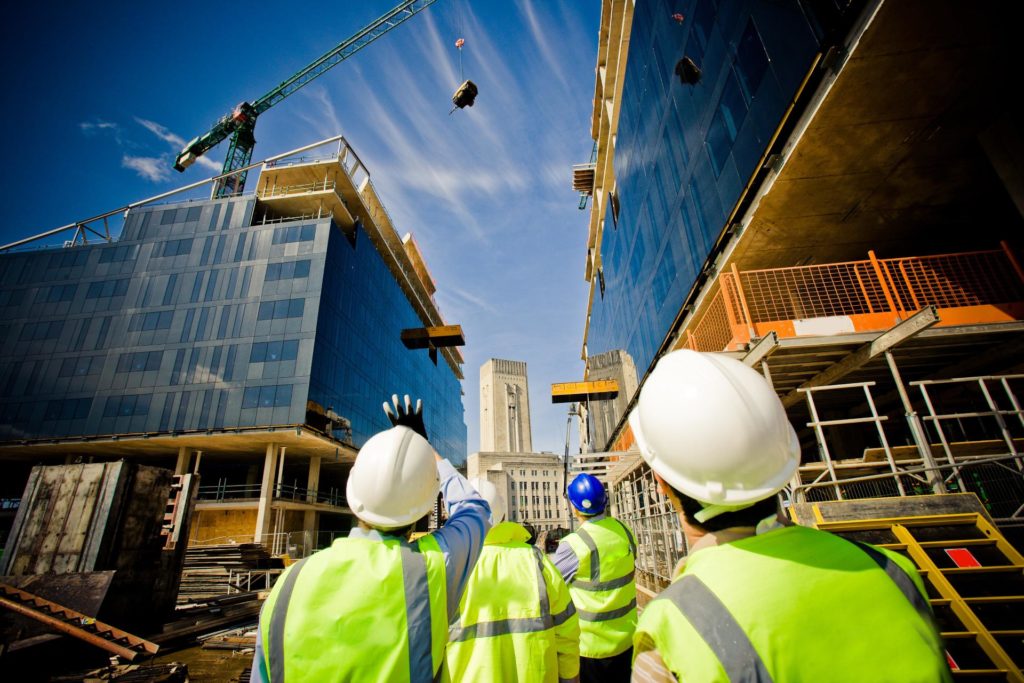 CSCS Cards member building under construction with workers