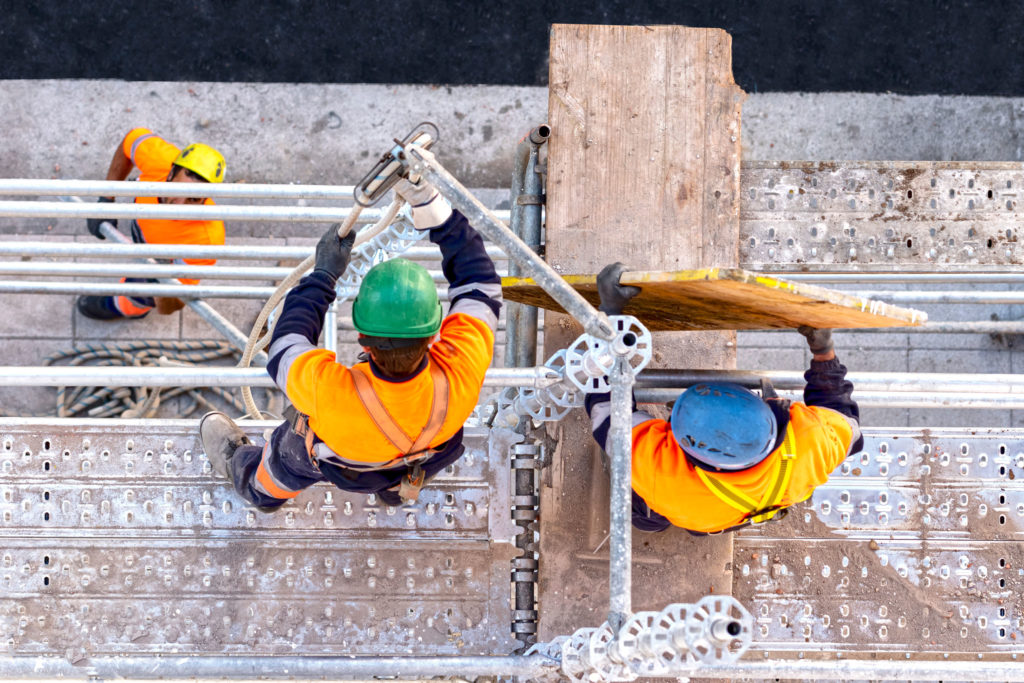 CITB Temporary Works Co-Ordinator Workers seen from above setting scaffolding on a facade